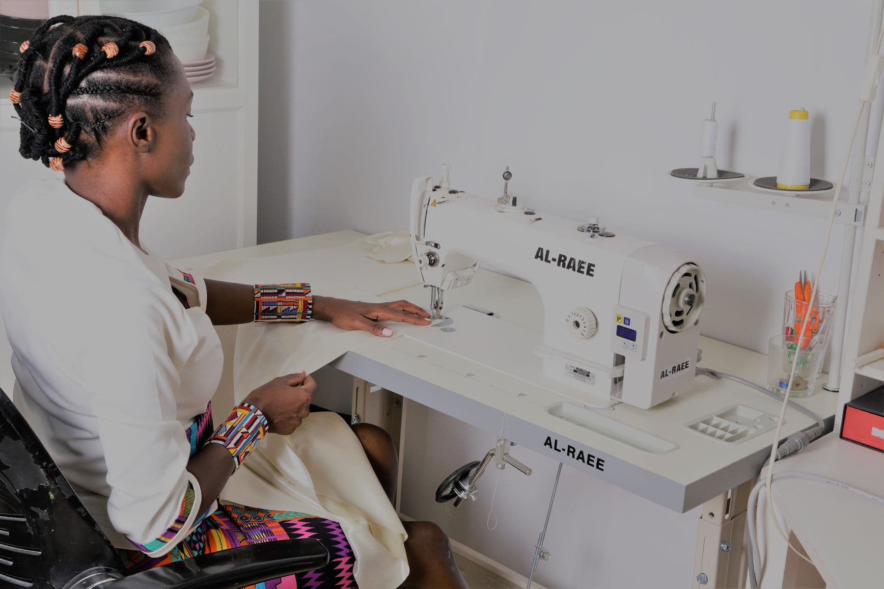 A seamstress at her sewing machine